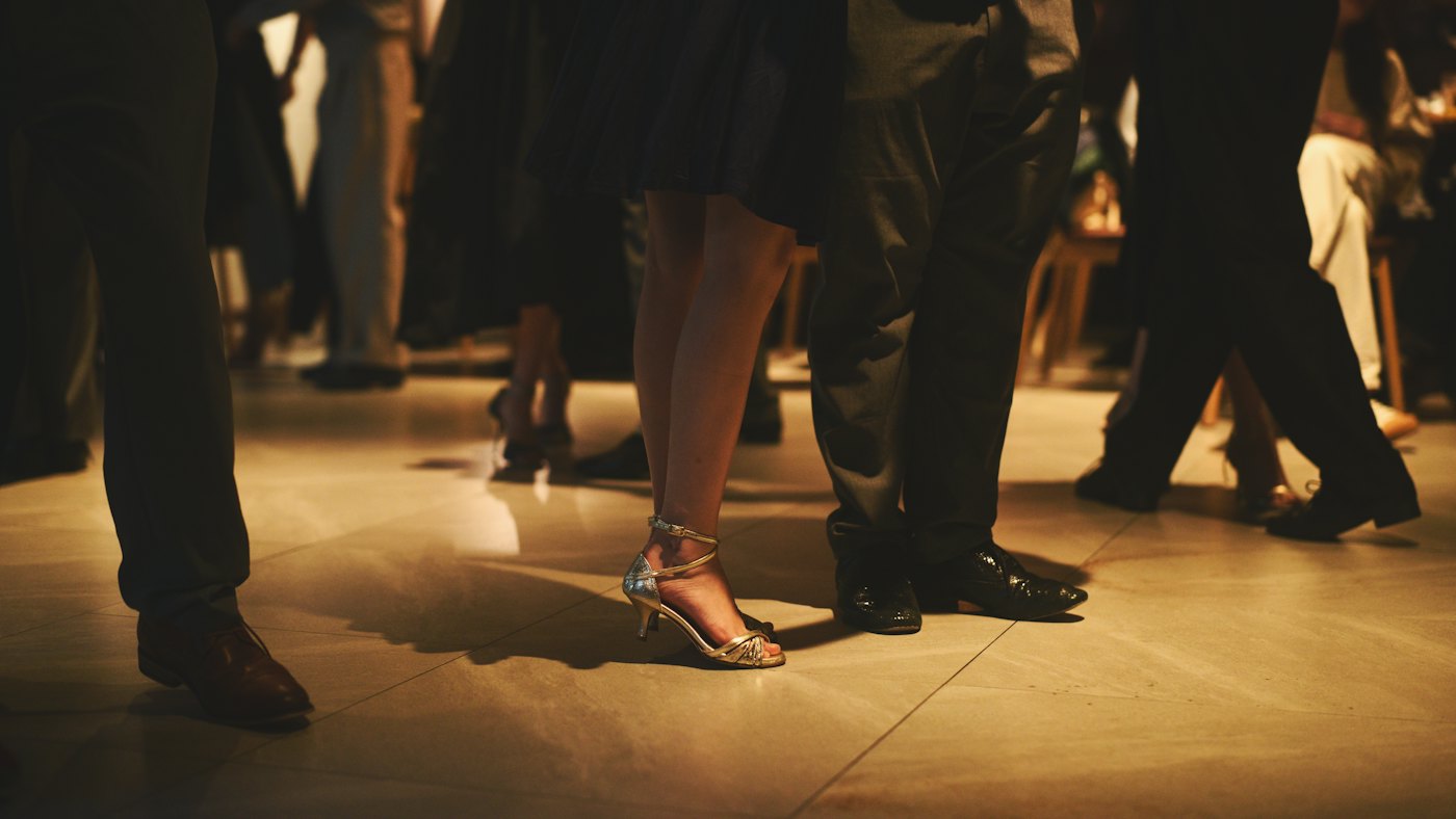 Gowns and polished shoes on a crowded dance floor